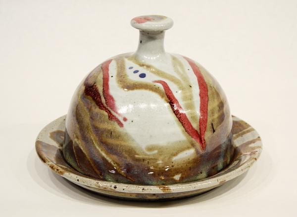 Multicolored hand thrown lidded serving dish made out of stoneware clay.