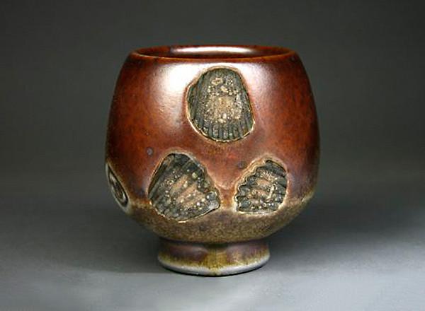 Rustic colored, hand thrown ceramic tea bowl with sea shell imprints.