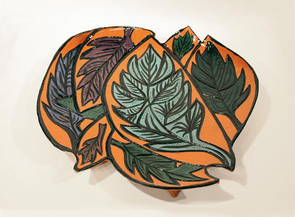 Handmade platter with brightly colored plant images.