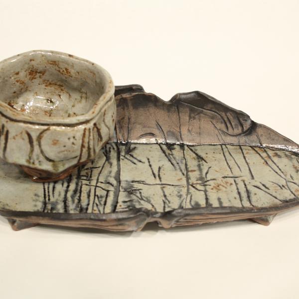 Handmade ceramic platter and cup with rustic surface