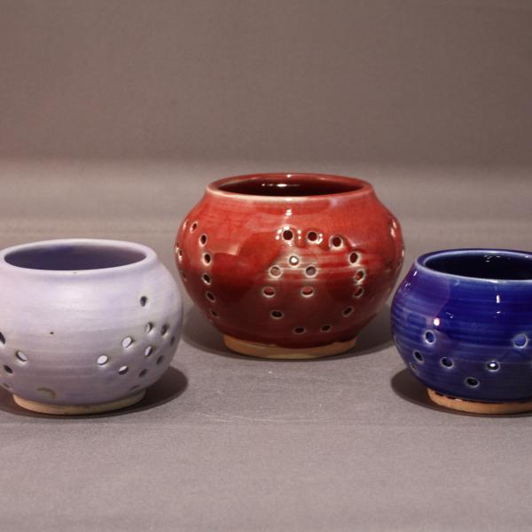 Three hand thrown ceramic tea lights with white, red and blue glazes