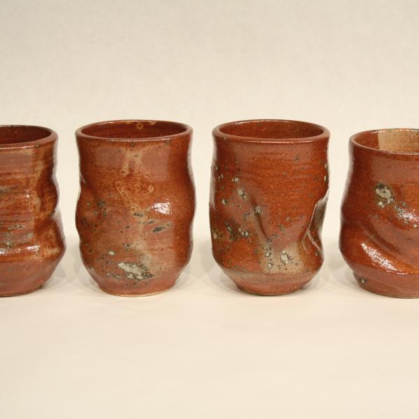 Set of four hand thrown ceramic tumblers with shino glaze